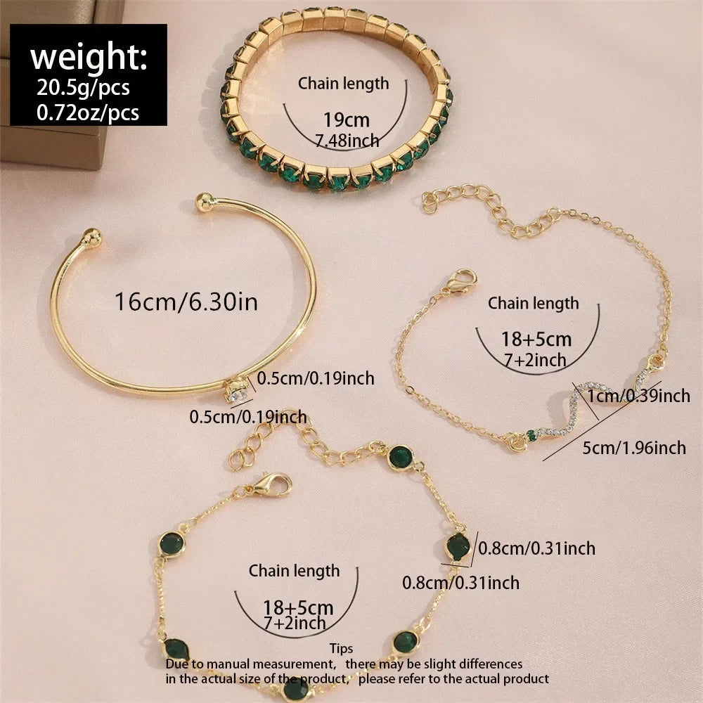 Gold bracelets with green gemstones and measurements on a beige background